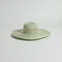Green sun hat on a light gray background