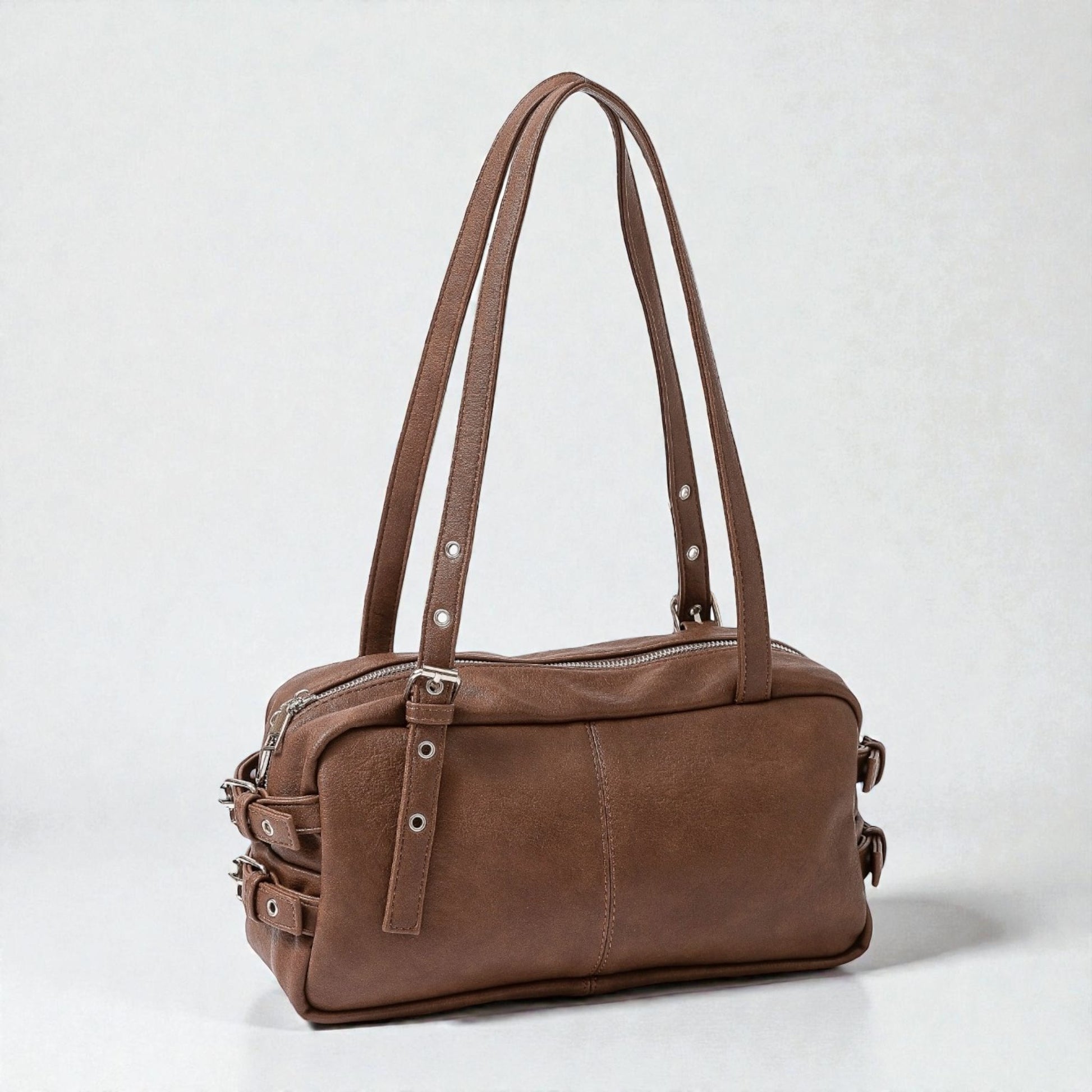 Brown leather handbag on a light gray background