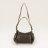 Brown leather handbag with a shoulder strap on a light beige background