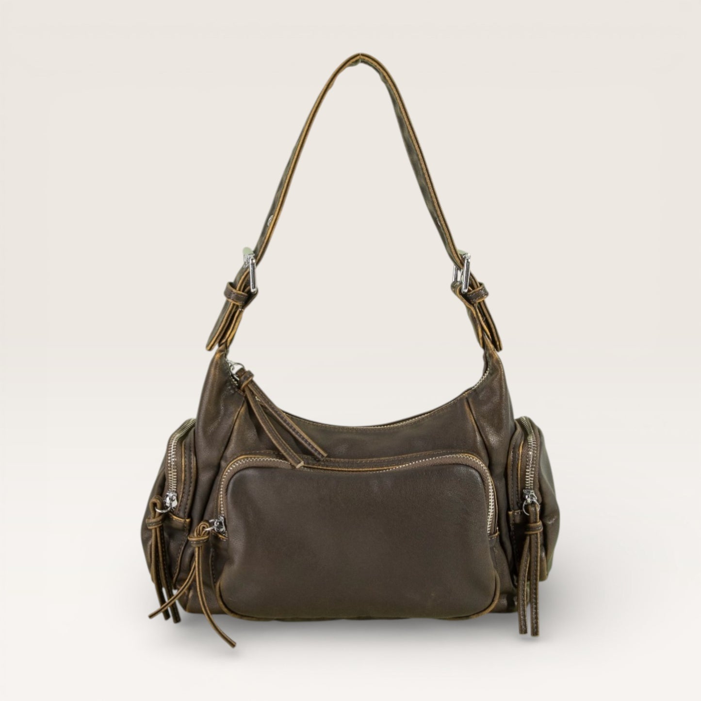 Brown leather handbag with multiple pockets on a light beige background