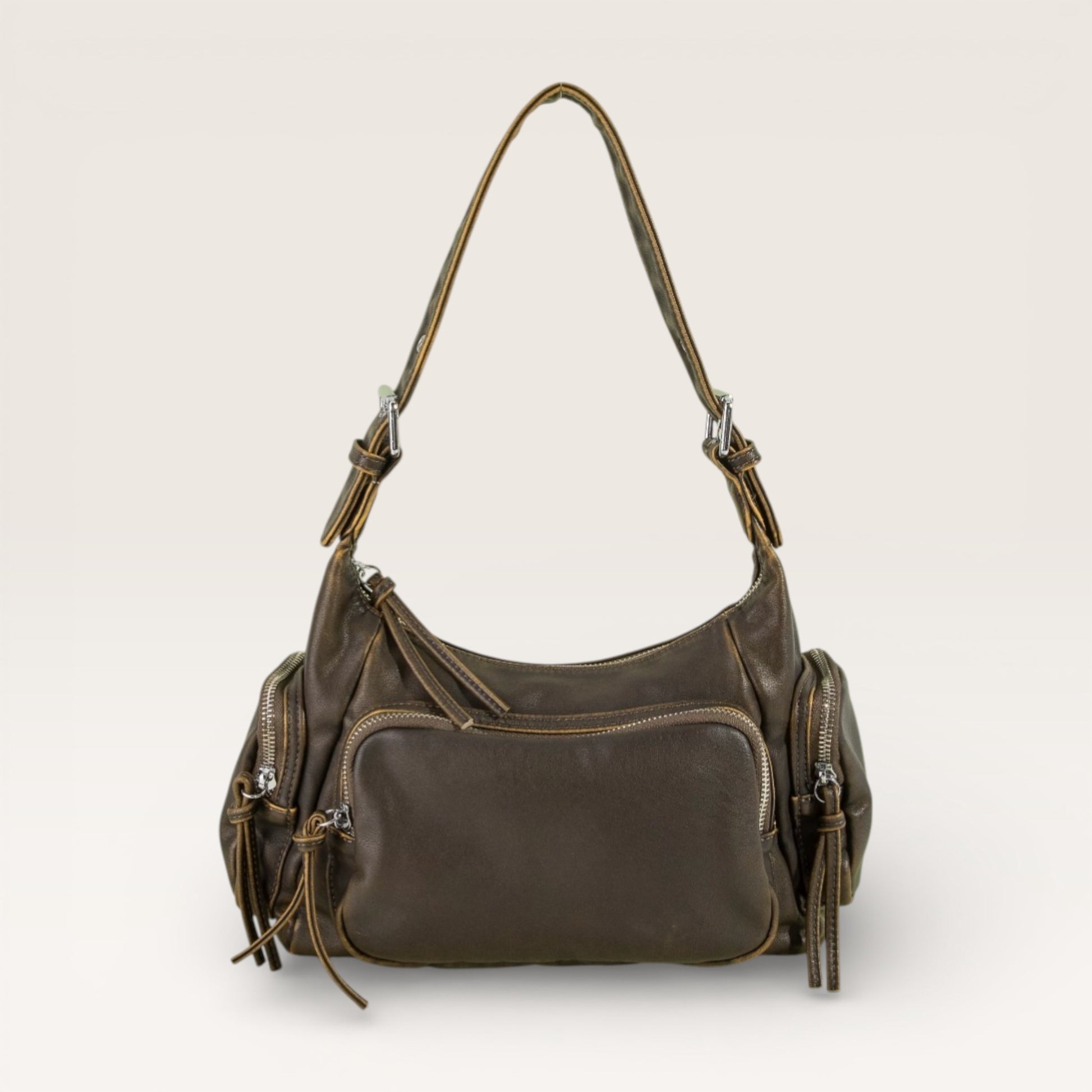Brown leather handbag with multiple pockets on a light beige background