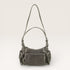 Gray handbag with multiple pockets on a light gray background