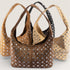 Brown handbag with silver studs on a white background