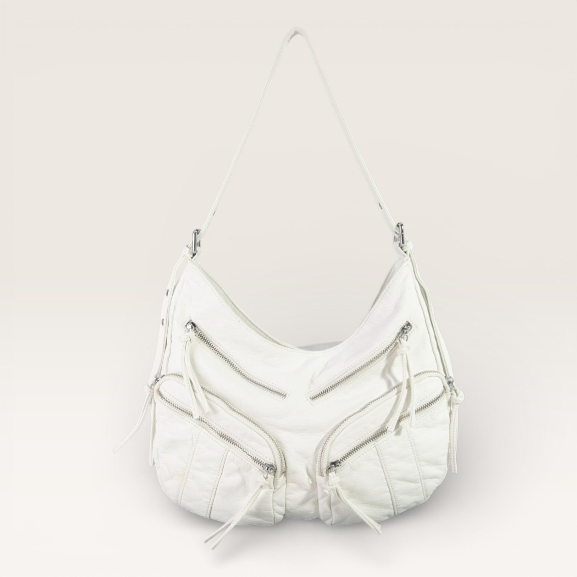 White handbag with zippers on a light gray background