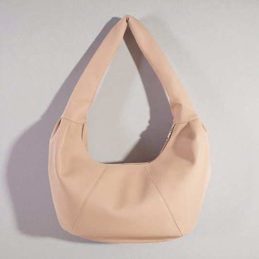 Beige handbag on a light gray background