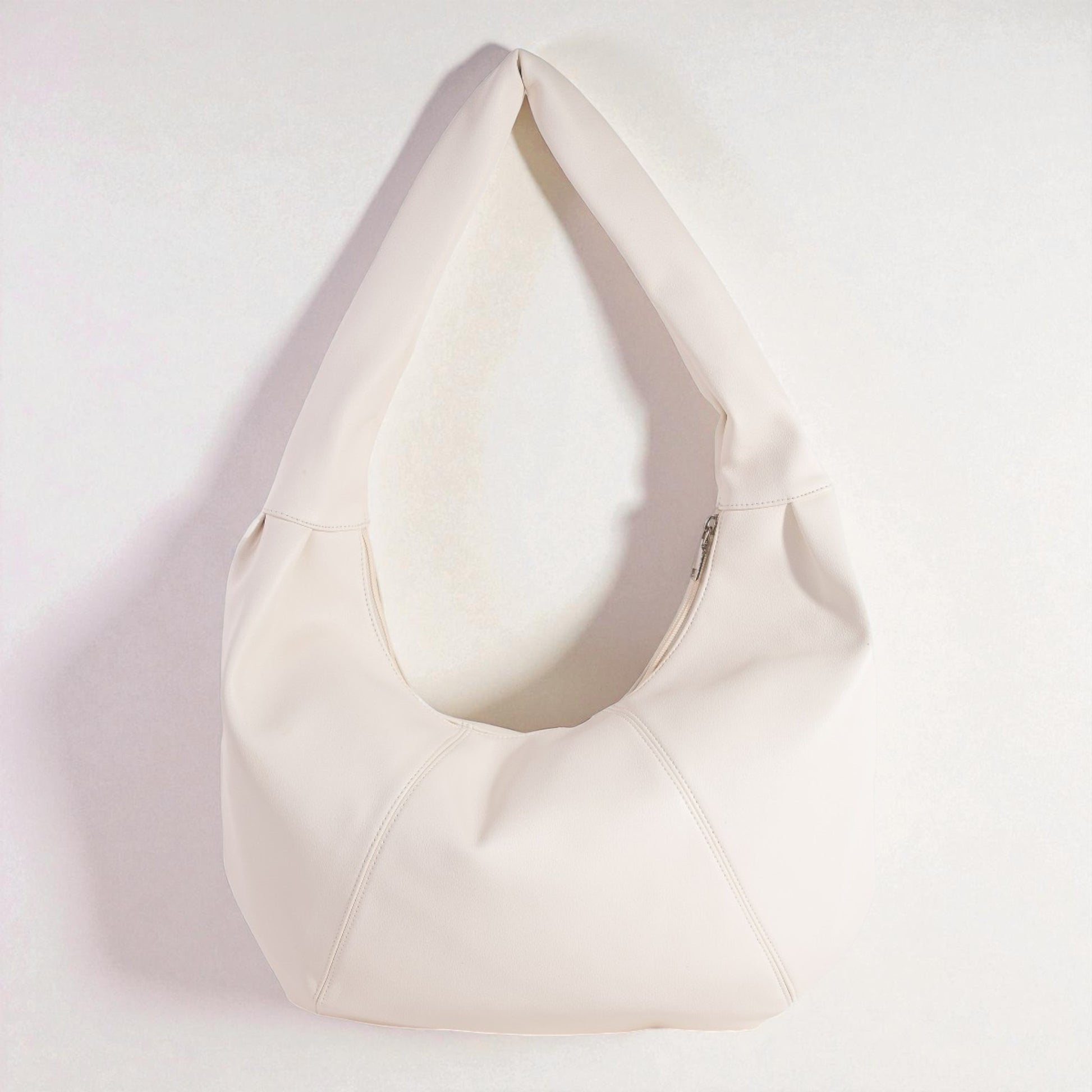 White bean bag chair on a light pink background