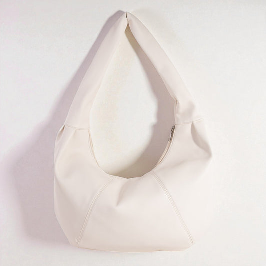 White bean bag chair on a light pink background