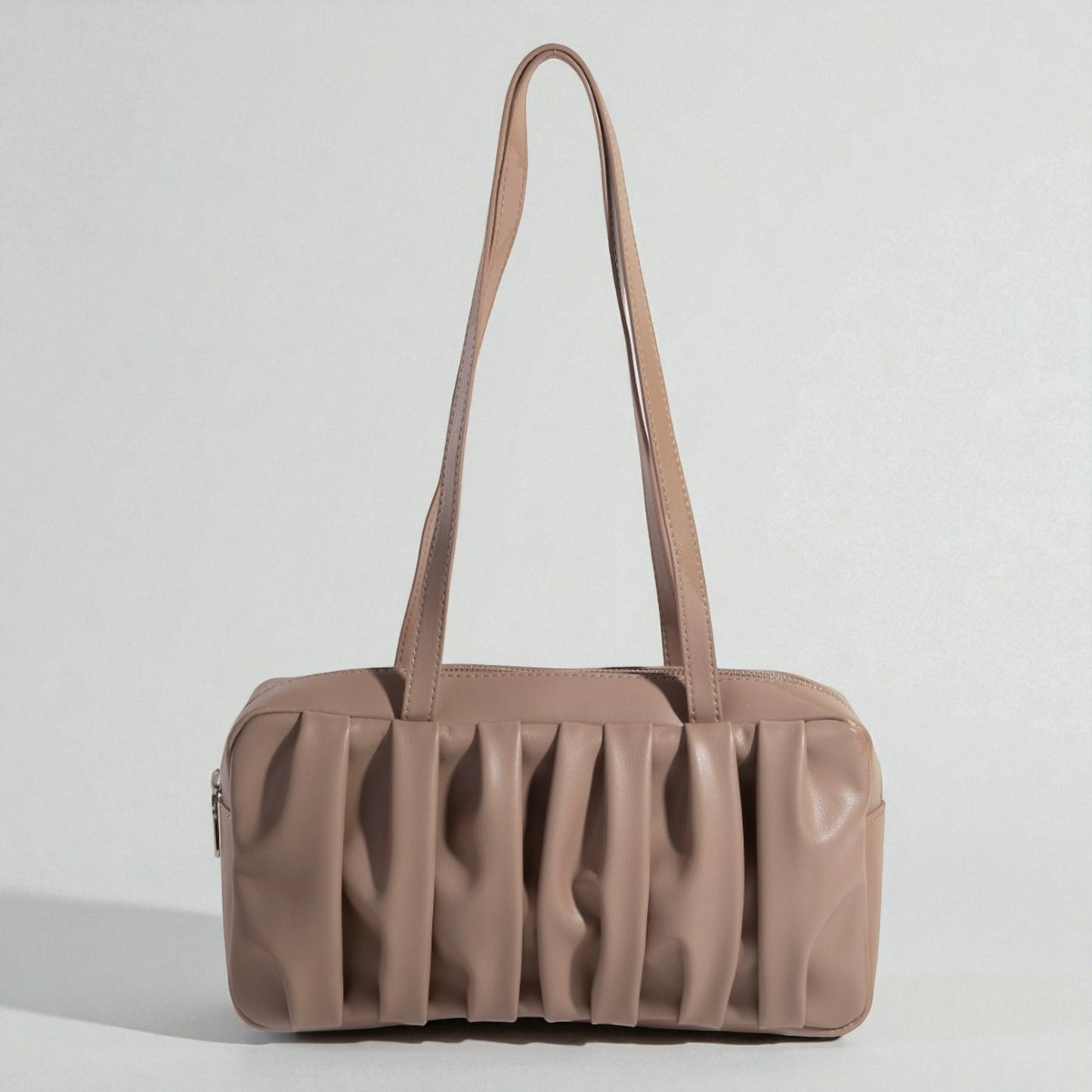 Brown handbag with a textured surface on a light gray background