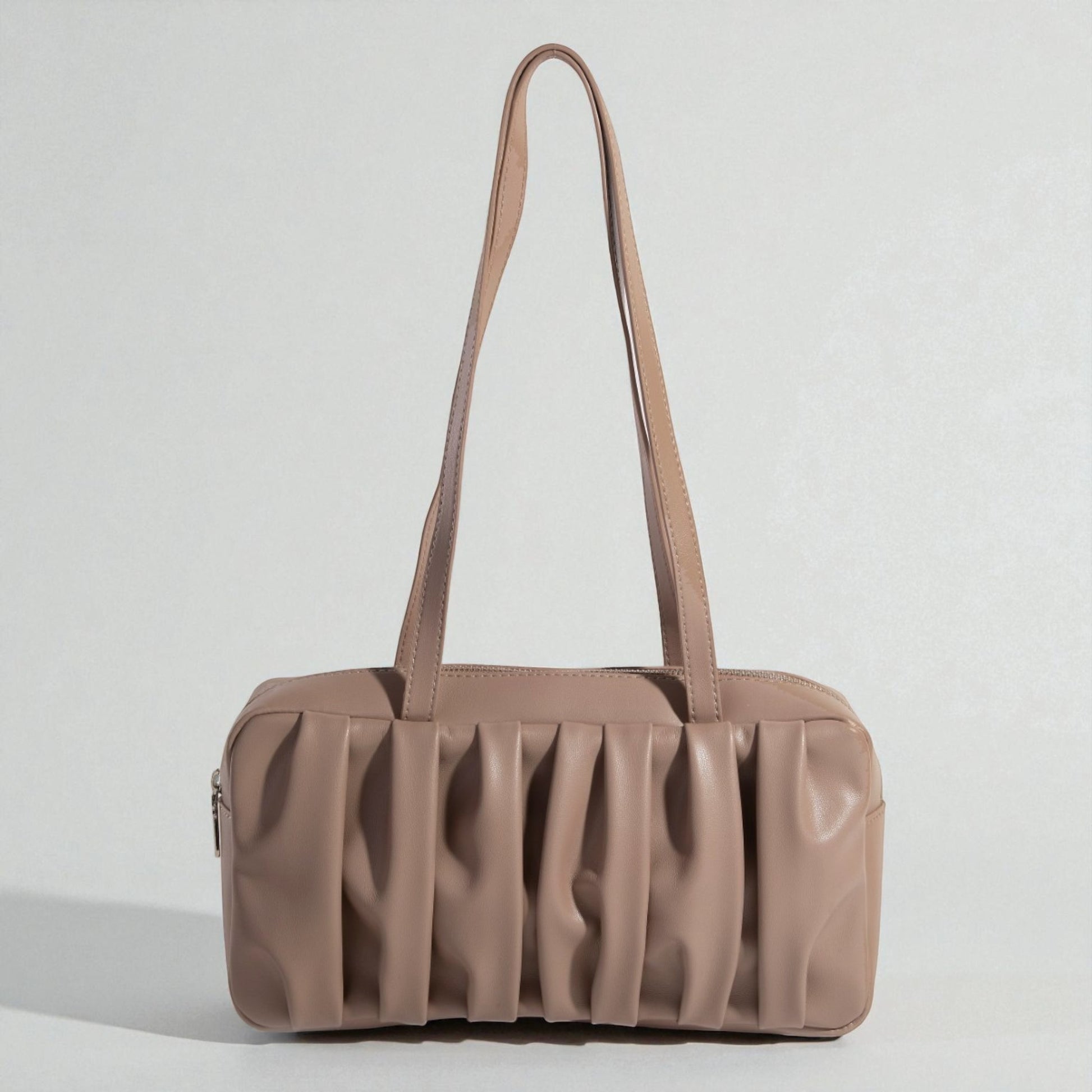 Brown handbag with a textured surface on a light gray background