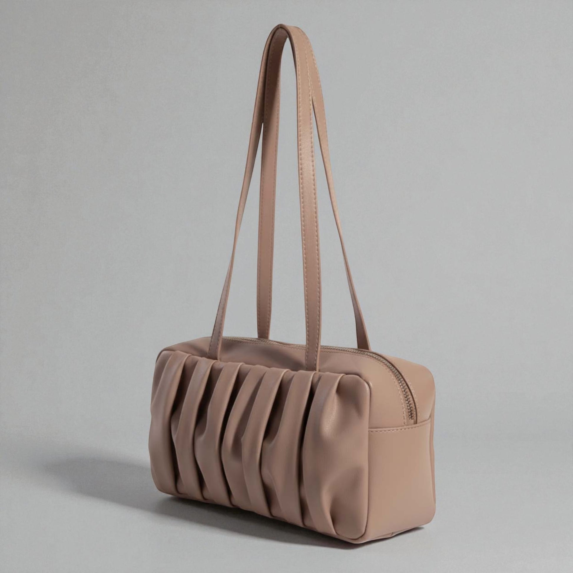 Beige handbag with pleated design on a gray background