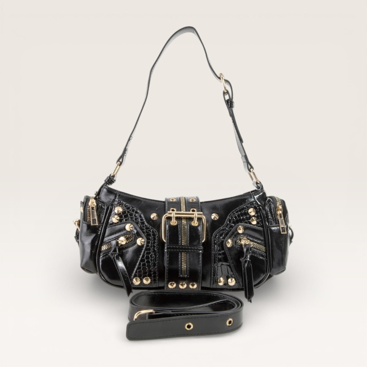 Black handbag with gold accents on a light gray background