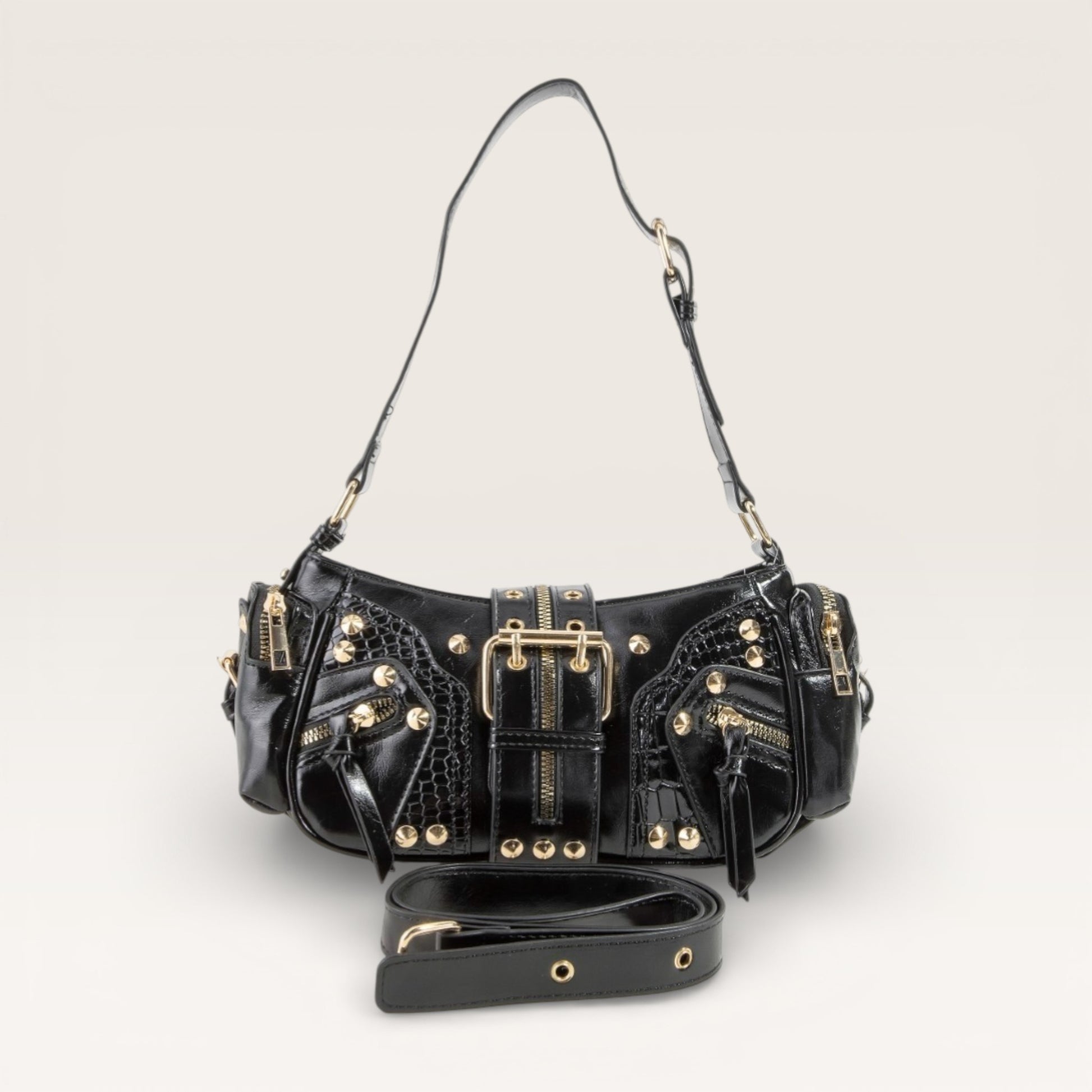 Black handbag with gold accents on a light gray background