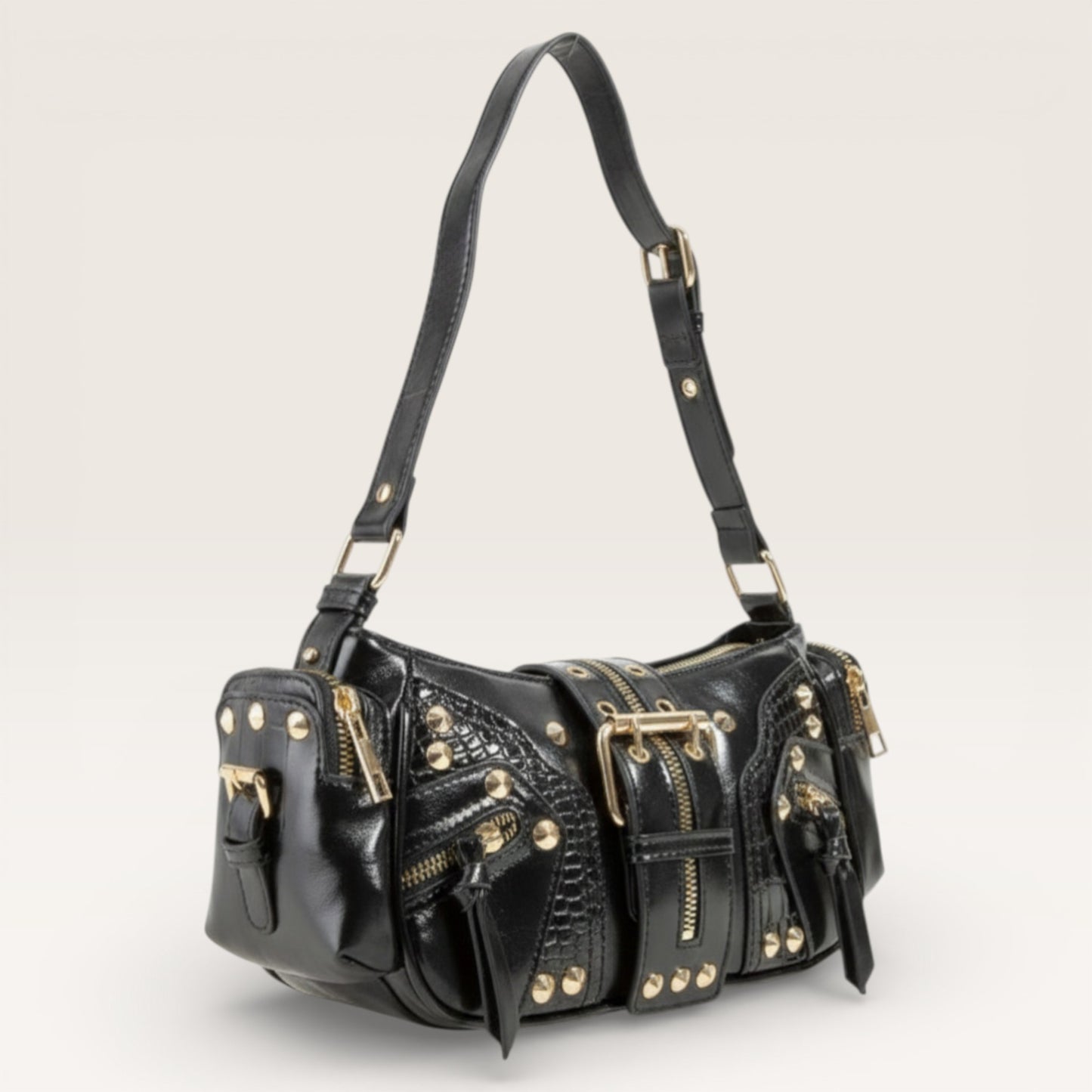 Black leather handbag with gold accents on a light gray background