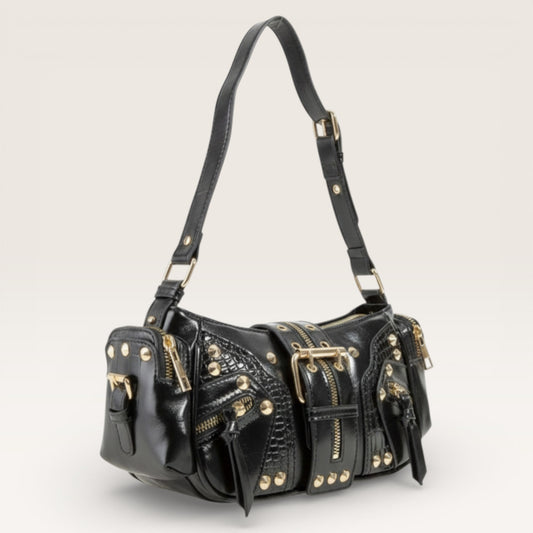 Black leather handbag with gold accents on a light gray background
