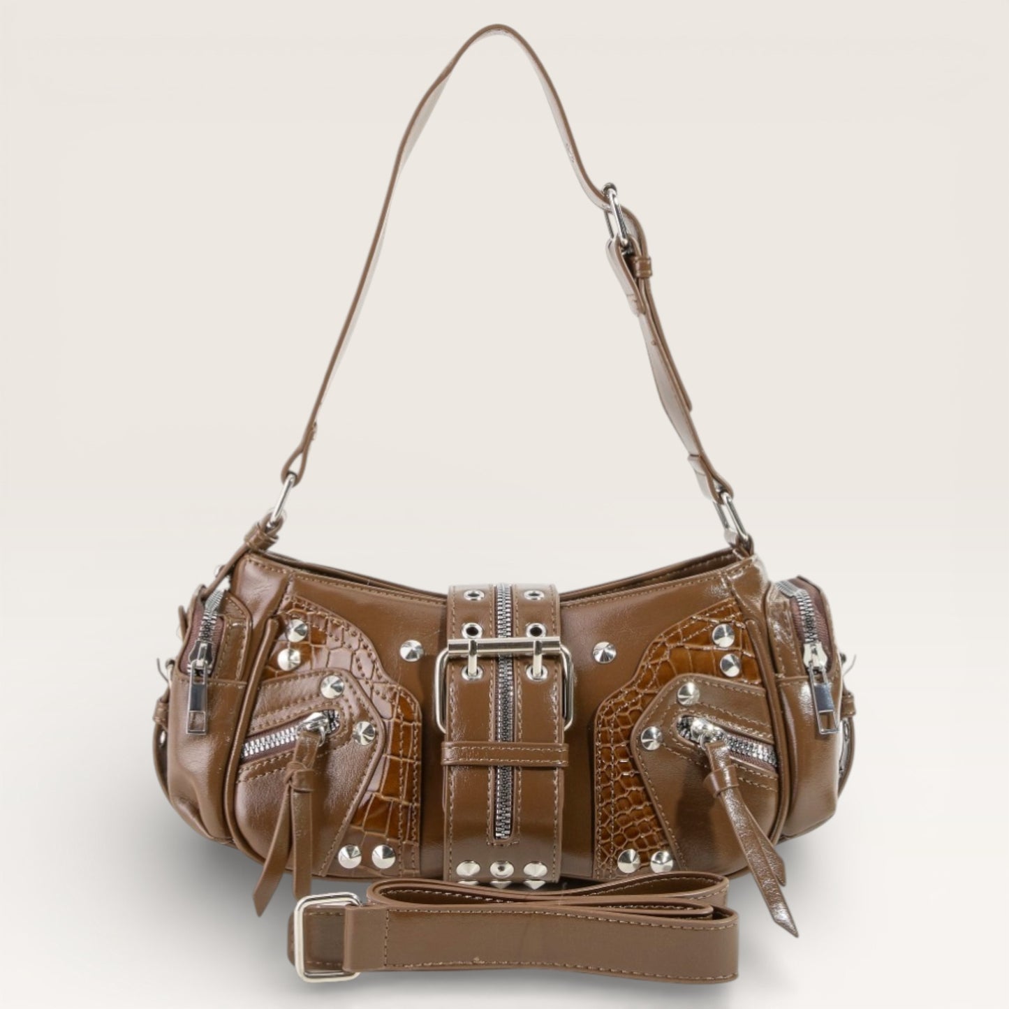 Brown leather handbag with silver accents on a light gray background