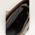 Close-up of a brown leather bag with a zipper, showing the interior.