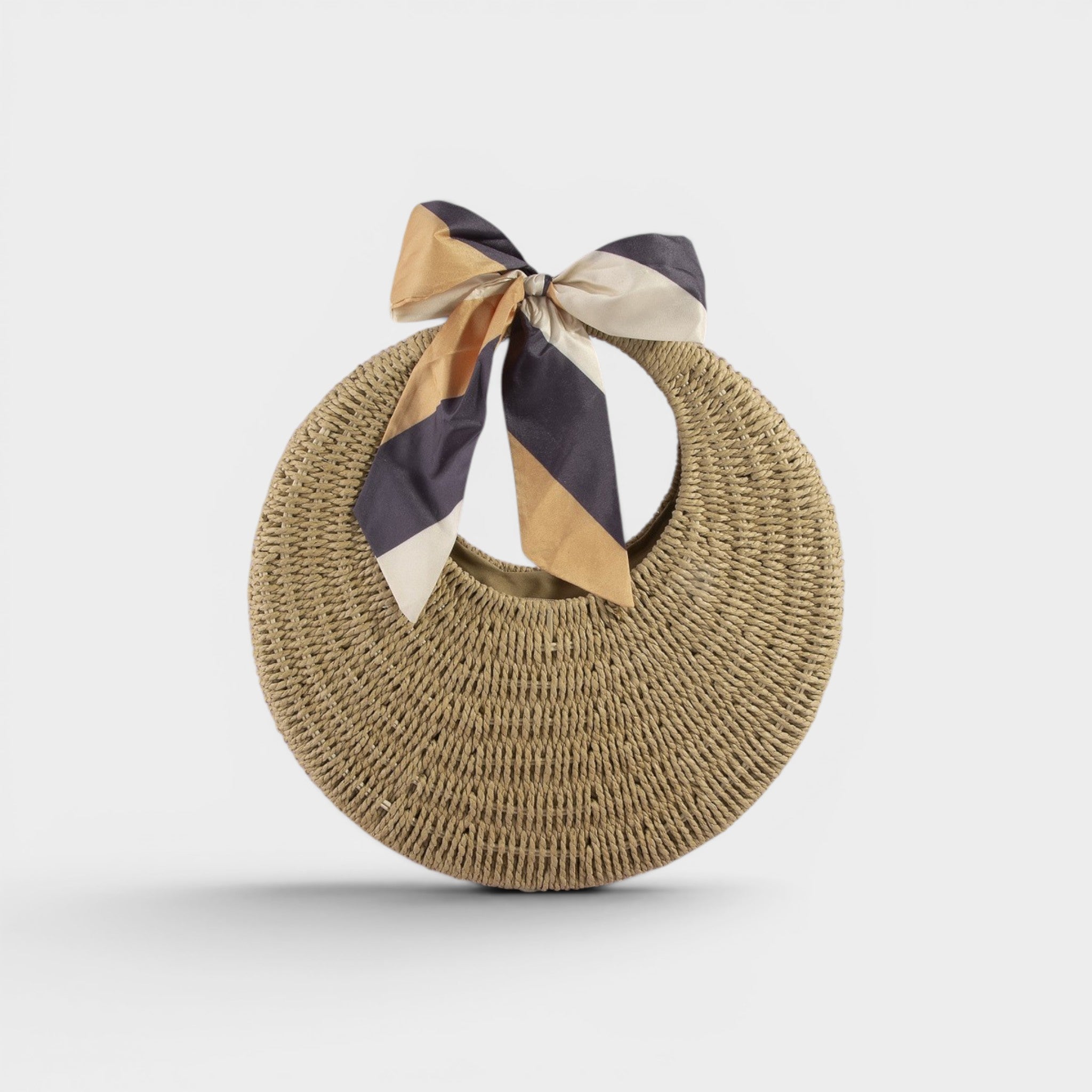 Round woven bag with a striped ribbon on a light gray background