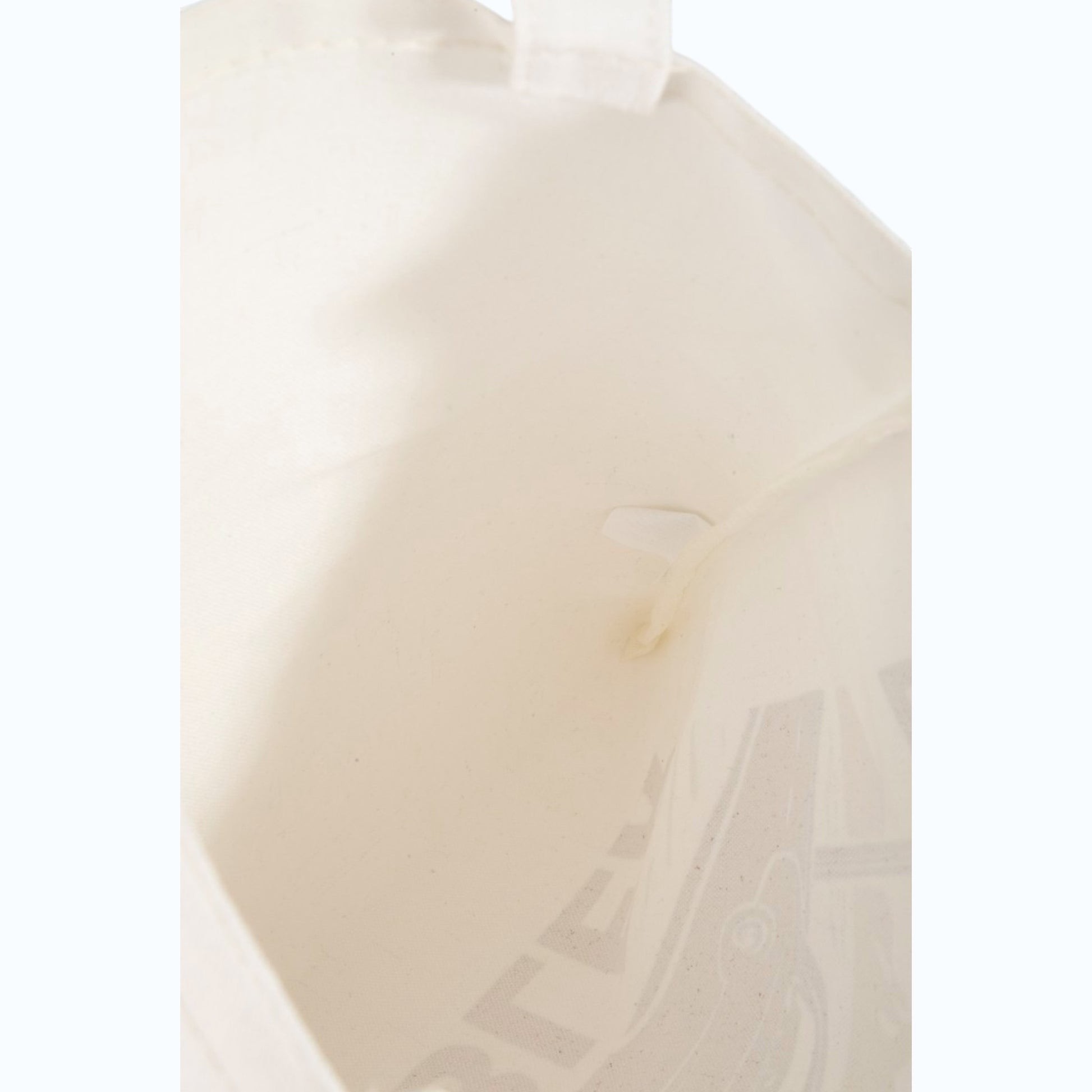 Close-up of a beige ceramic plate with subtle patterns on a white background