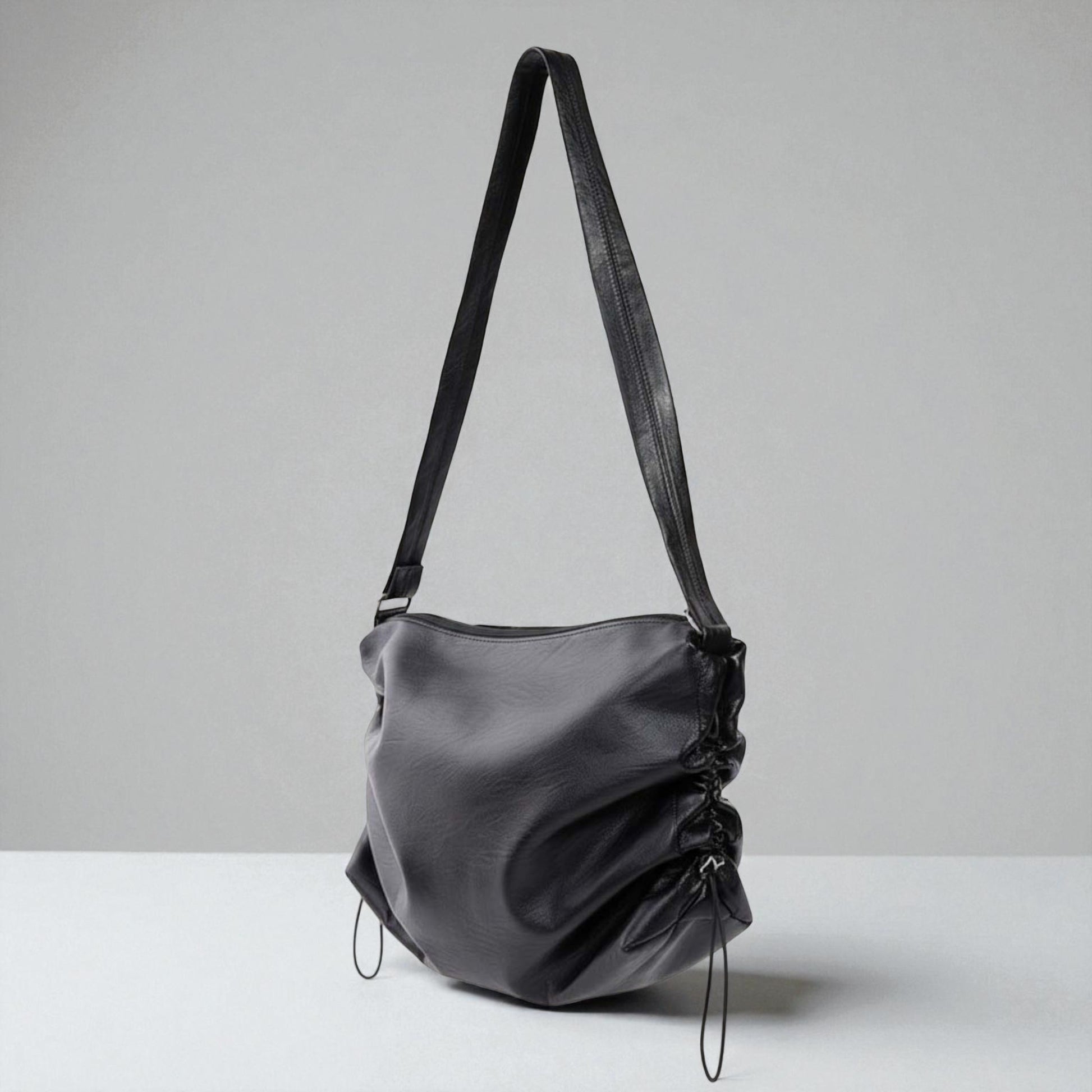 Black shoulder bag on a light gray background