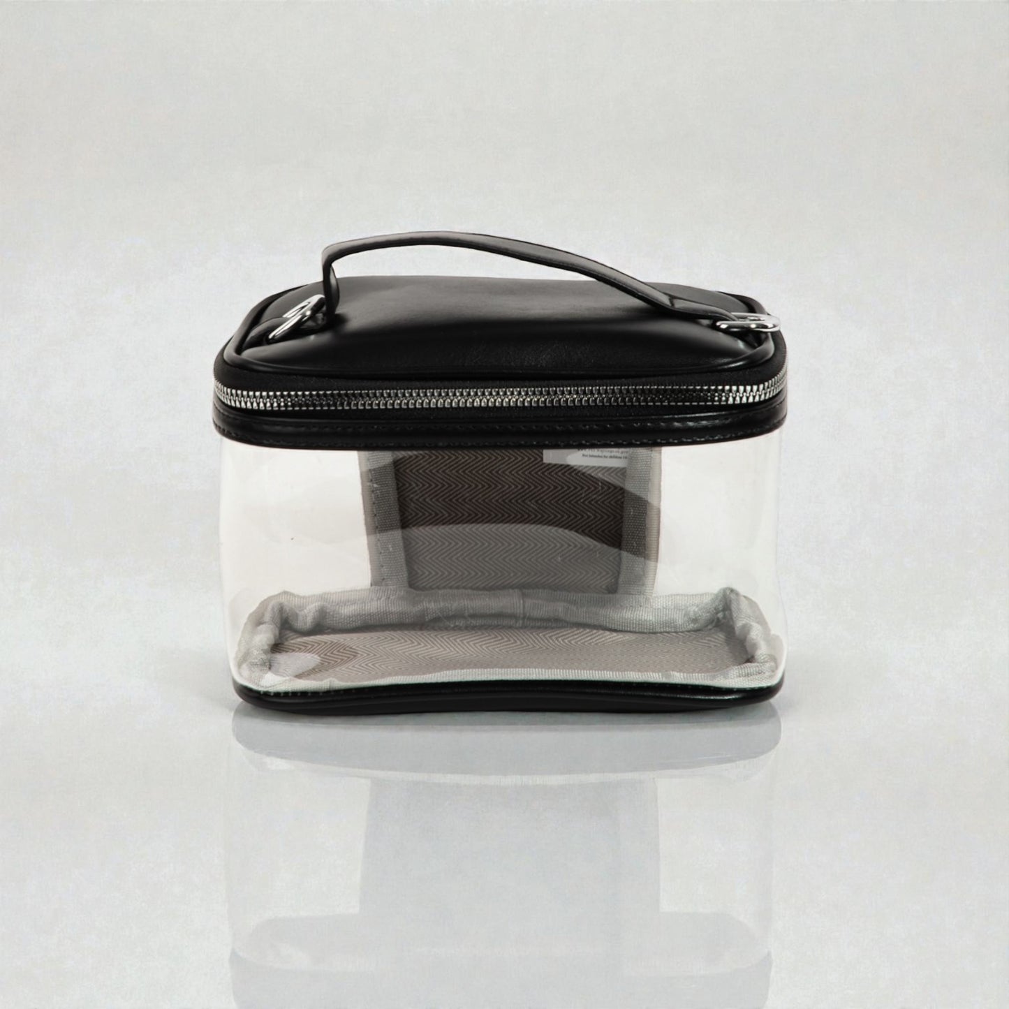 Clear travel case with black lid on a white background