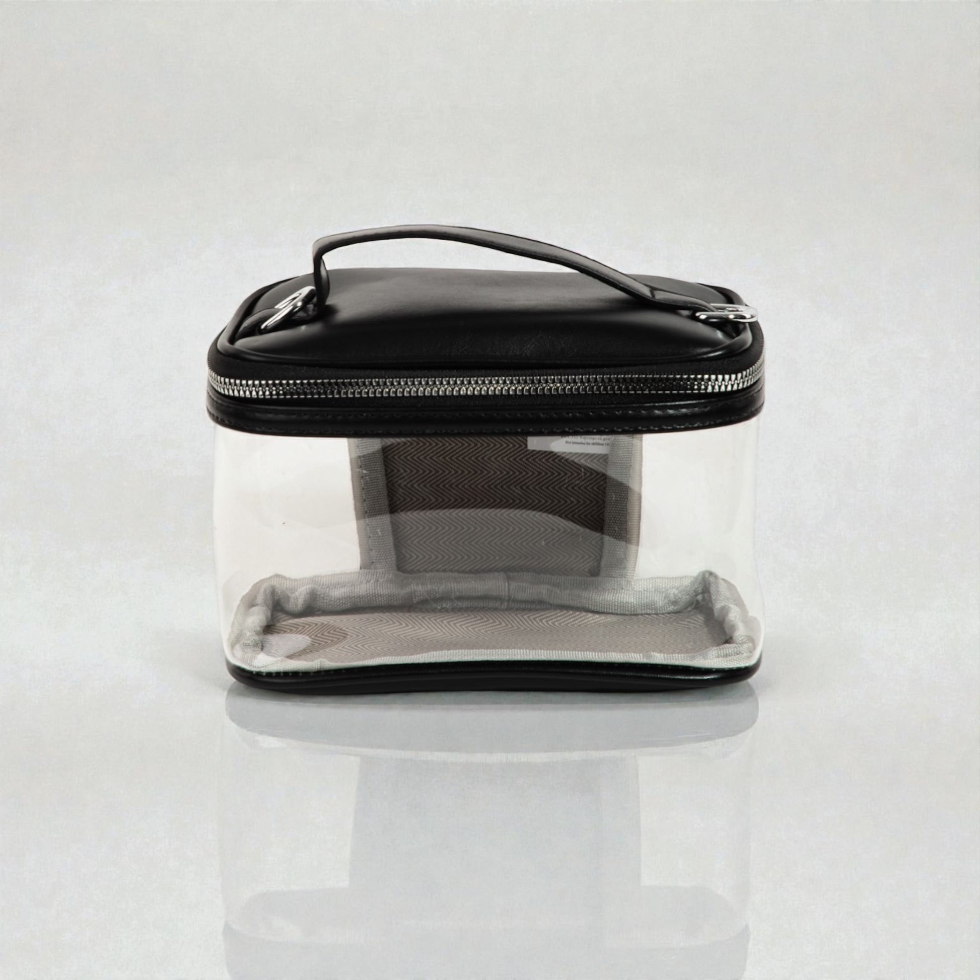Clear travel case with black lid on a white background