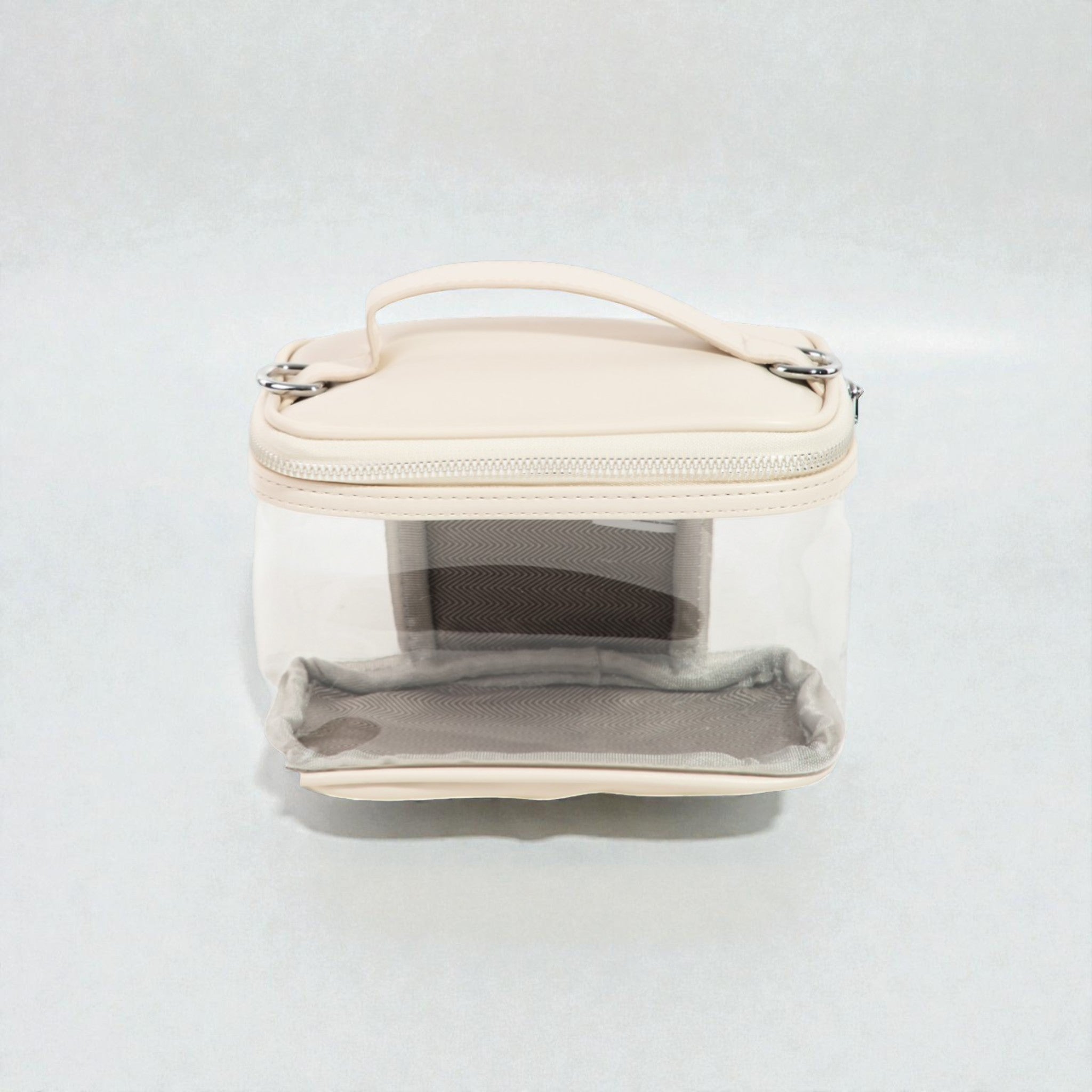 Clear cosmetic bag with beige top section on a white background