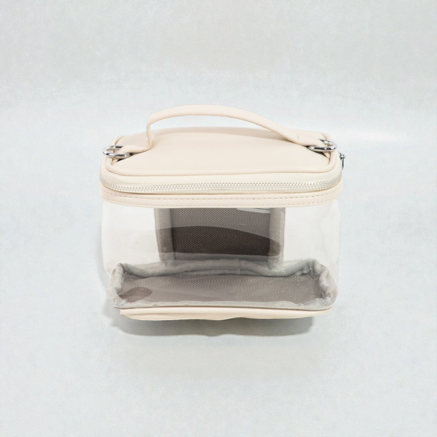 Clear cosmetic bag with beige top section on a white background