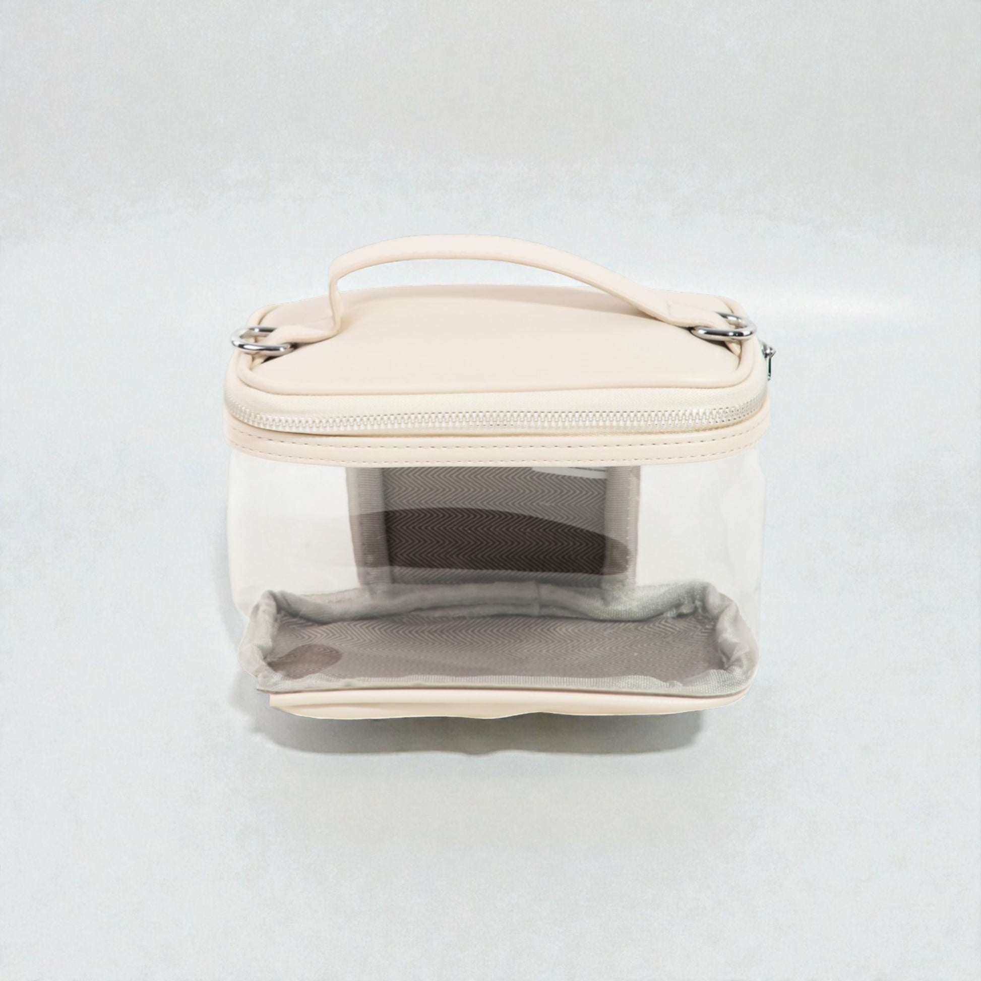 Clear cosmetic bag with beige top section on a white background