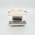 Clear cosmetic bag with beige top section on a white background