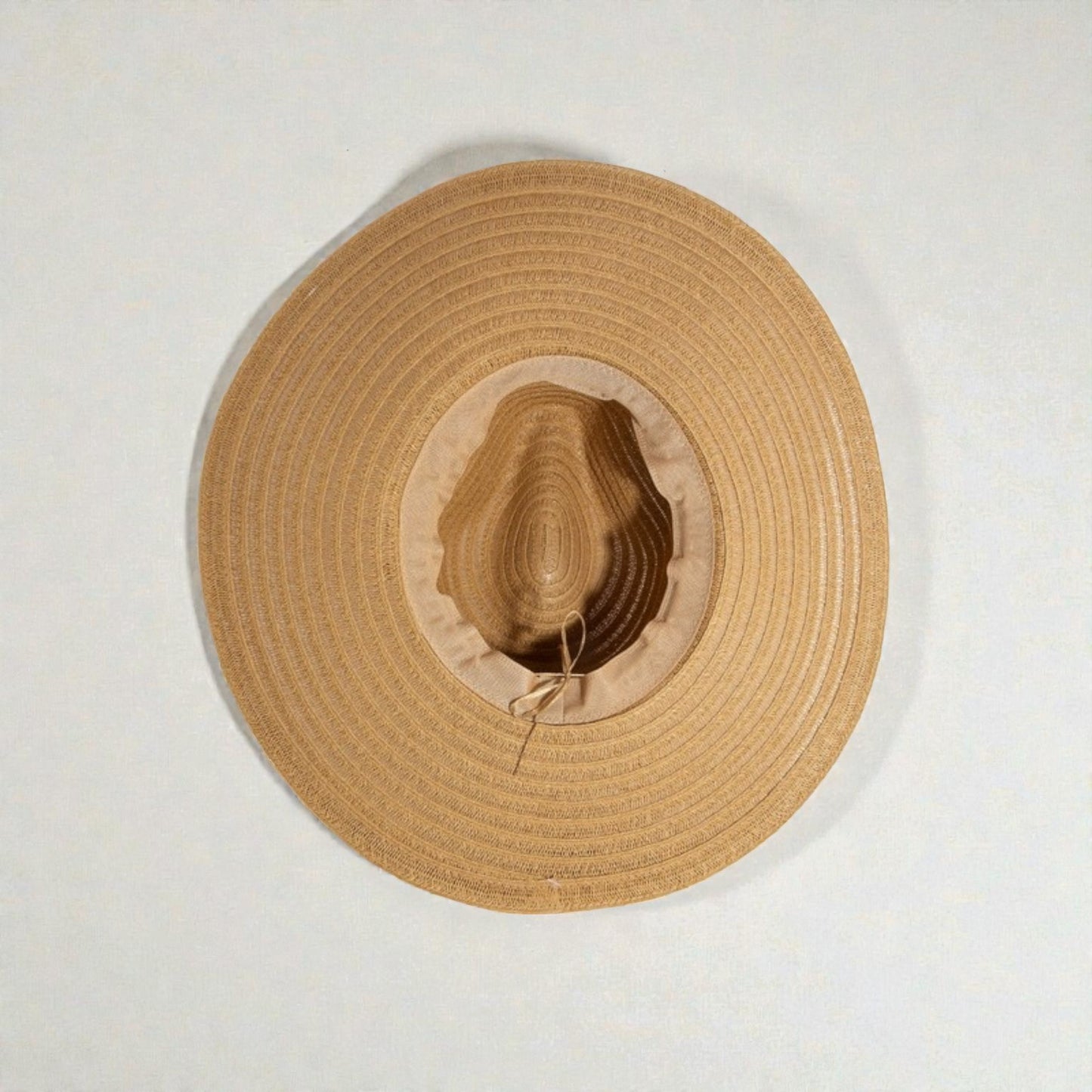 Beige straw hat on a white background