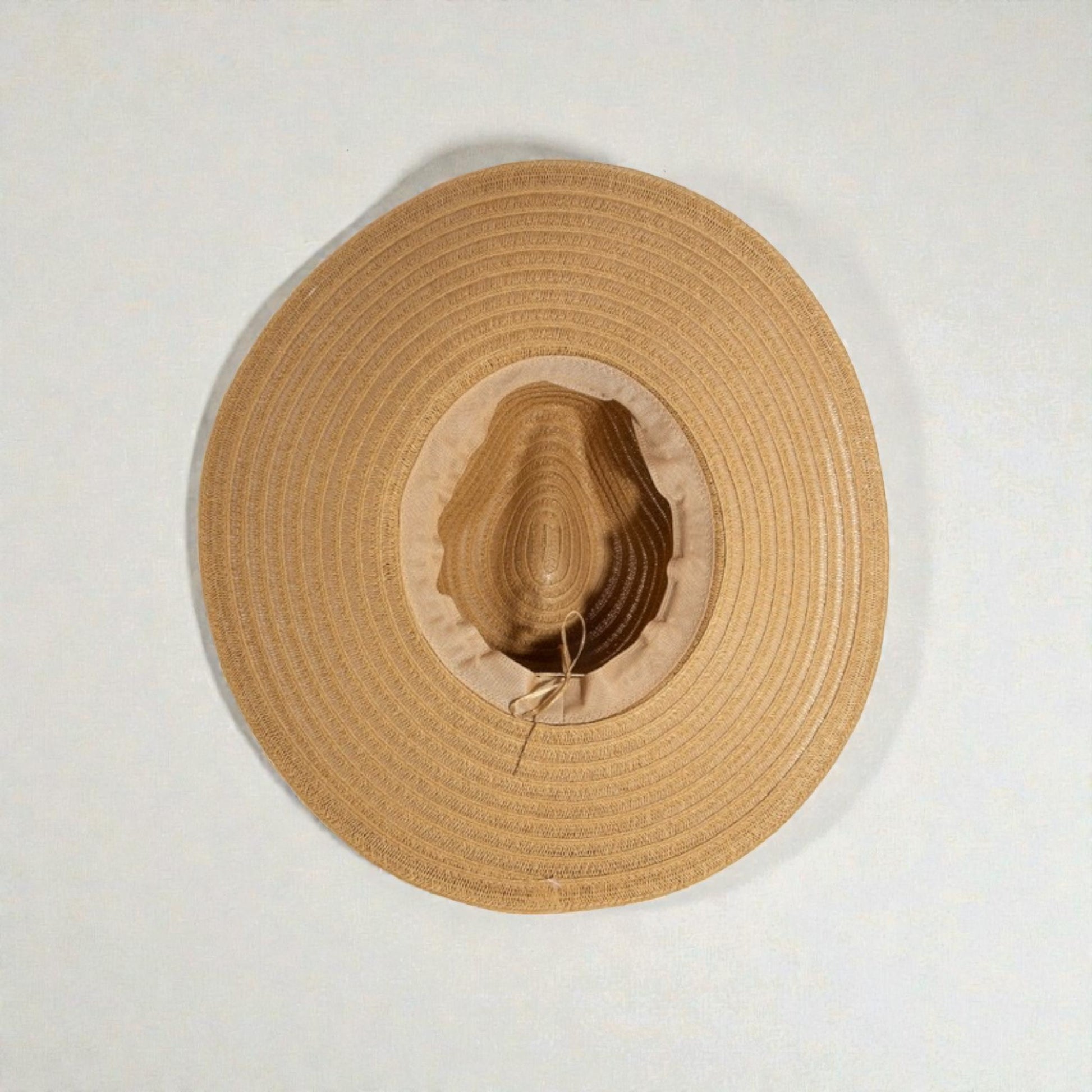 Beige straw hat on a white background