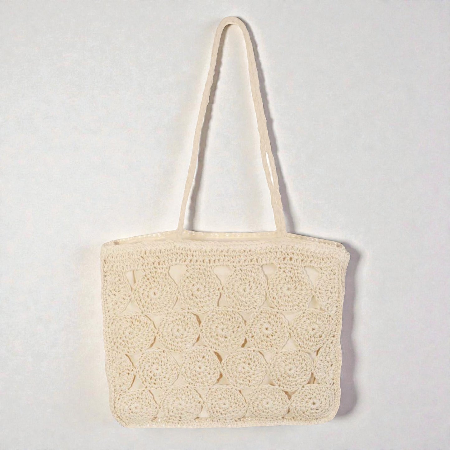 Beige woven handbag on a light gray background