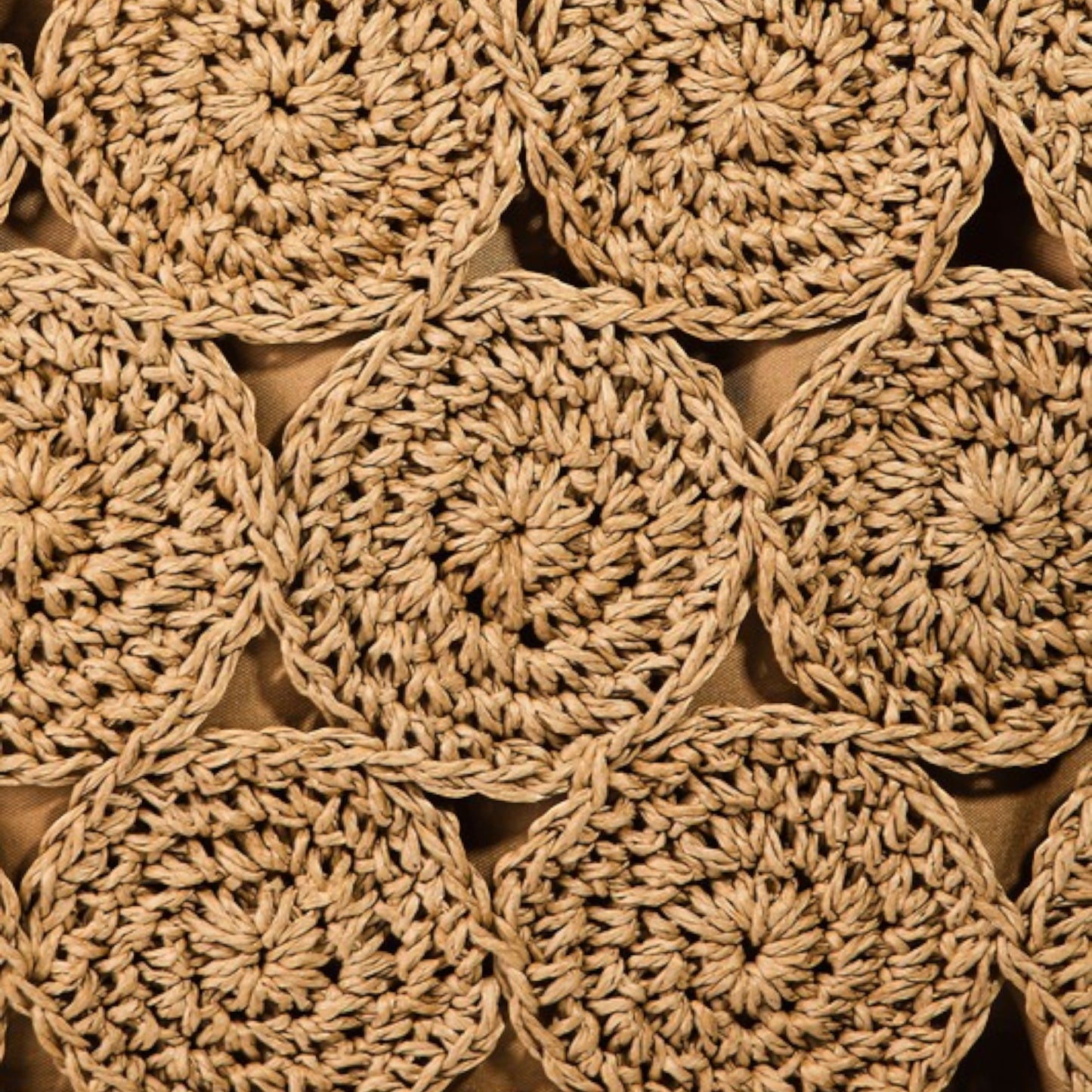 Close-up of beige crocheted circular patterns