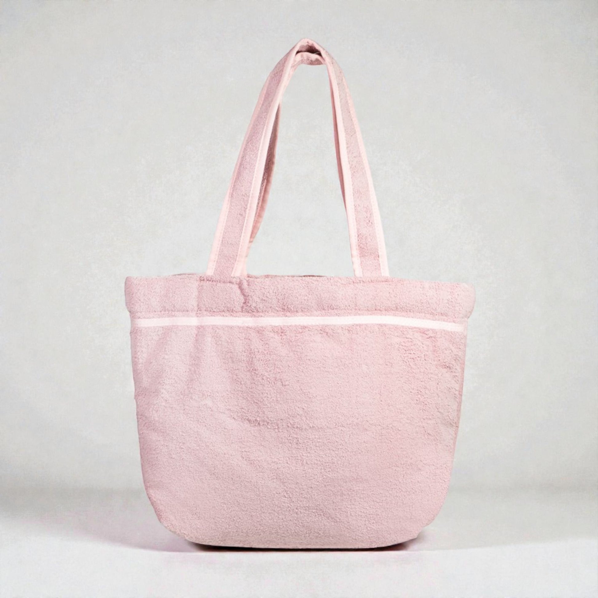 Pink tote bag with white stripe on a light gray background
