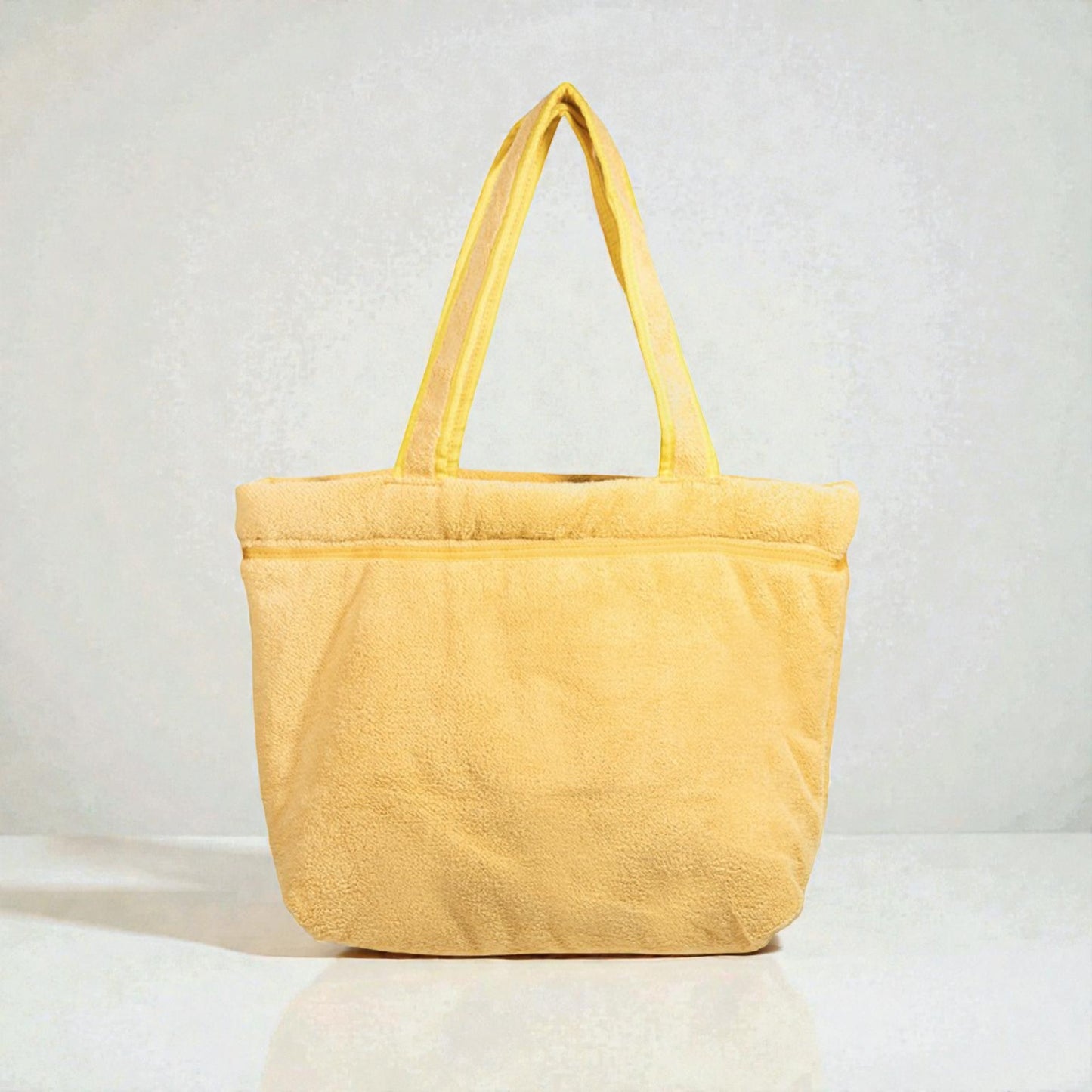 Yellow tote bag on a light gray background