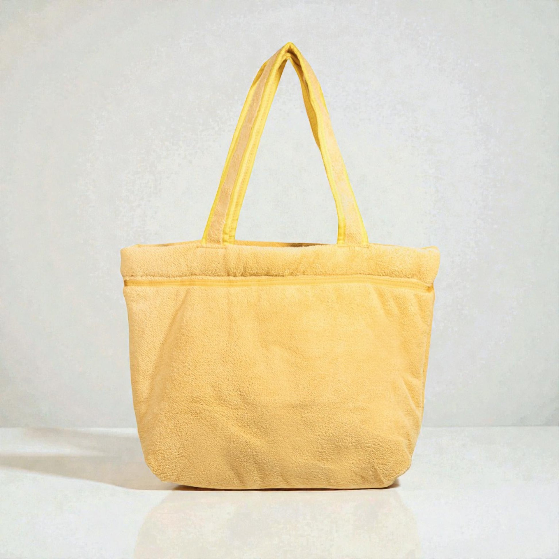 Yellow tote bag on a light gray background