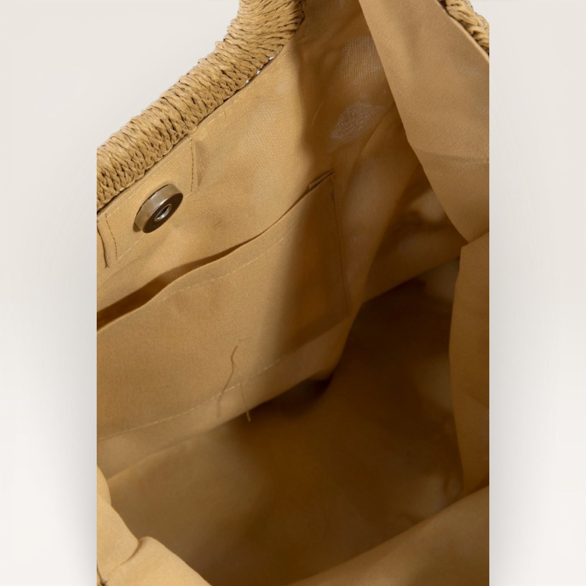 Close-up of a brown jacket with a textured collar and button detail.