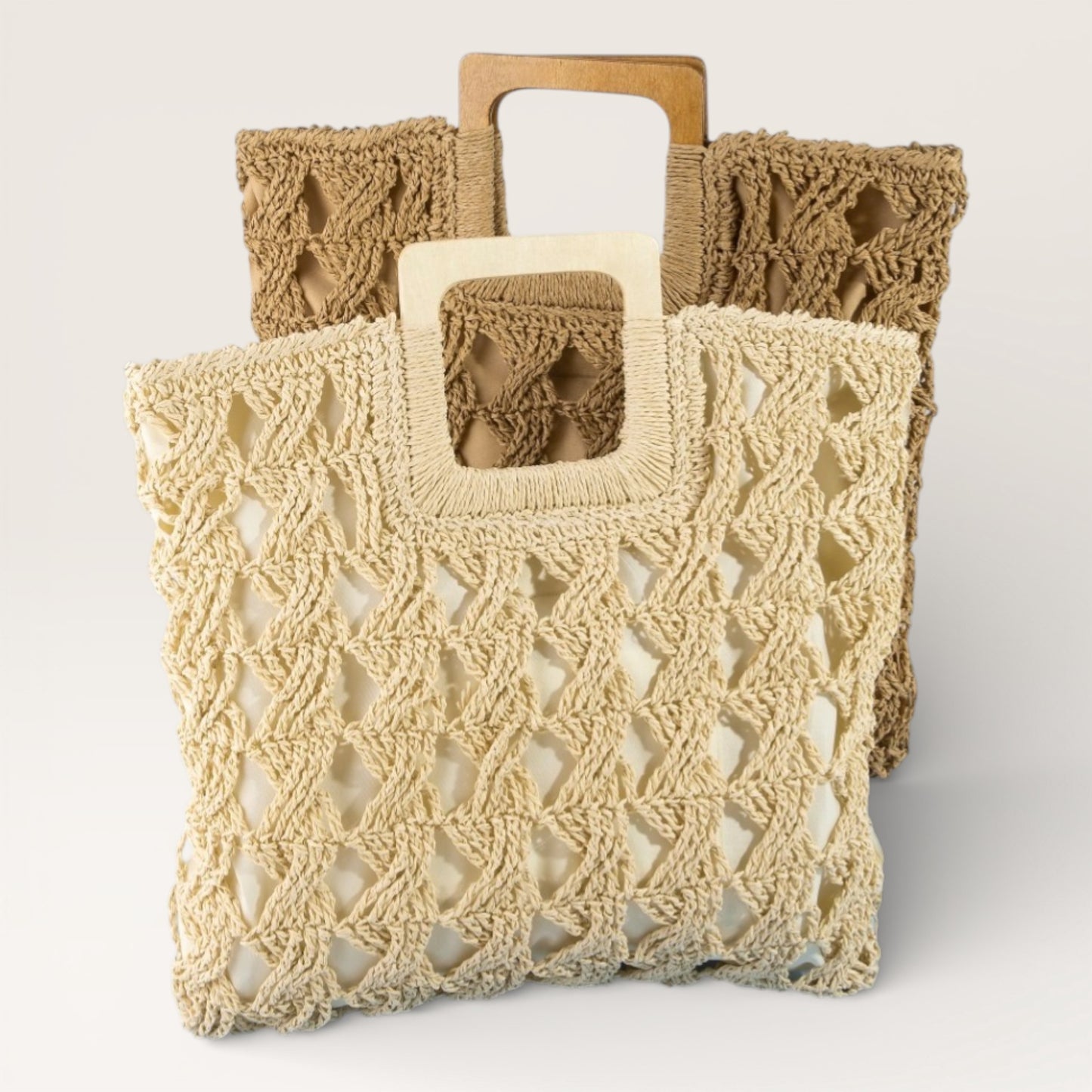 Two crocheted bags, one beige and one brown, on a light gray background.
