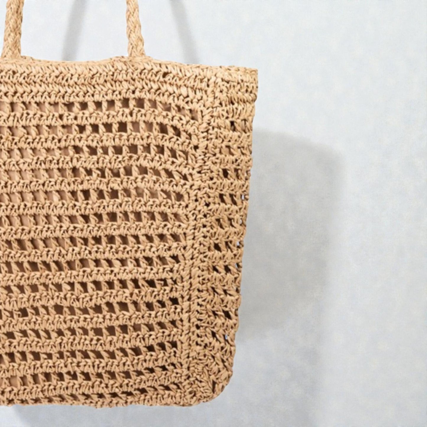 Woven straw bag on a white background