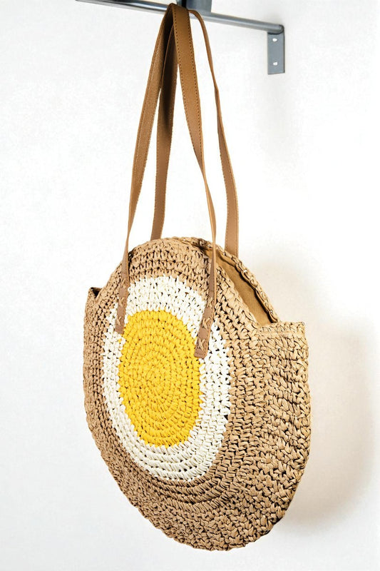Woven handbag with a yellow and white design on a white background