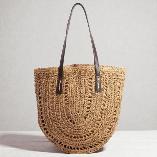 Woven handbag with leather straps on a light gray background