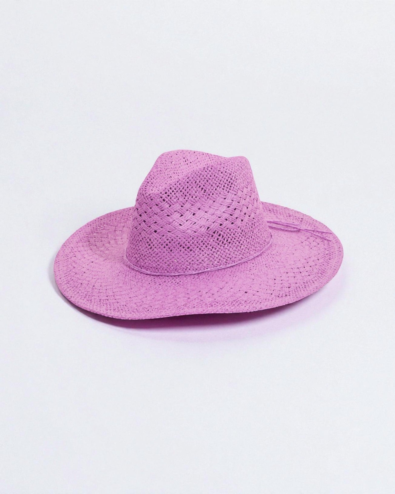 Purple straw hat on a light purple background