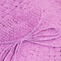 Close-up of pink yarn on a textured pink fabric background