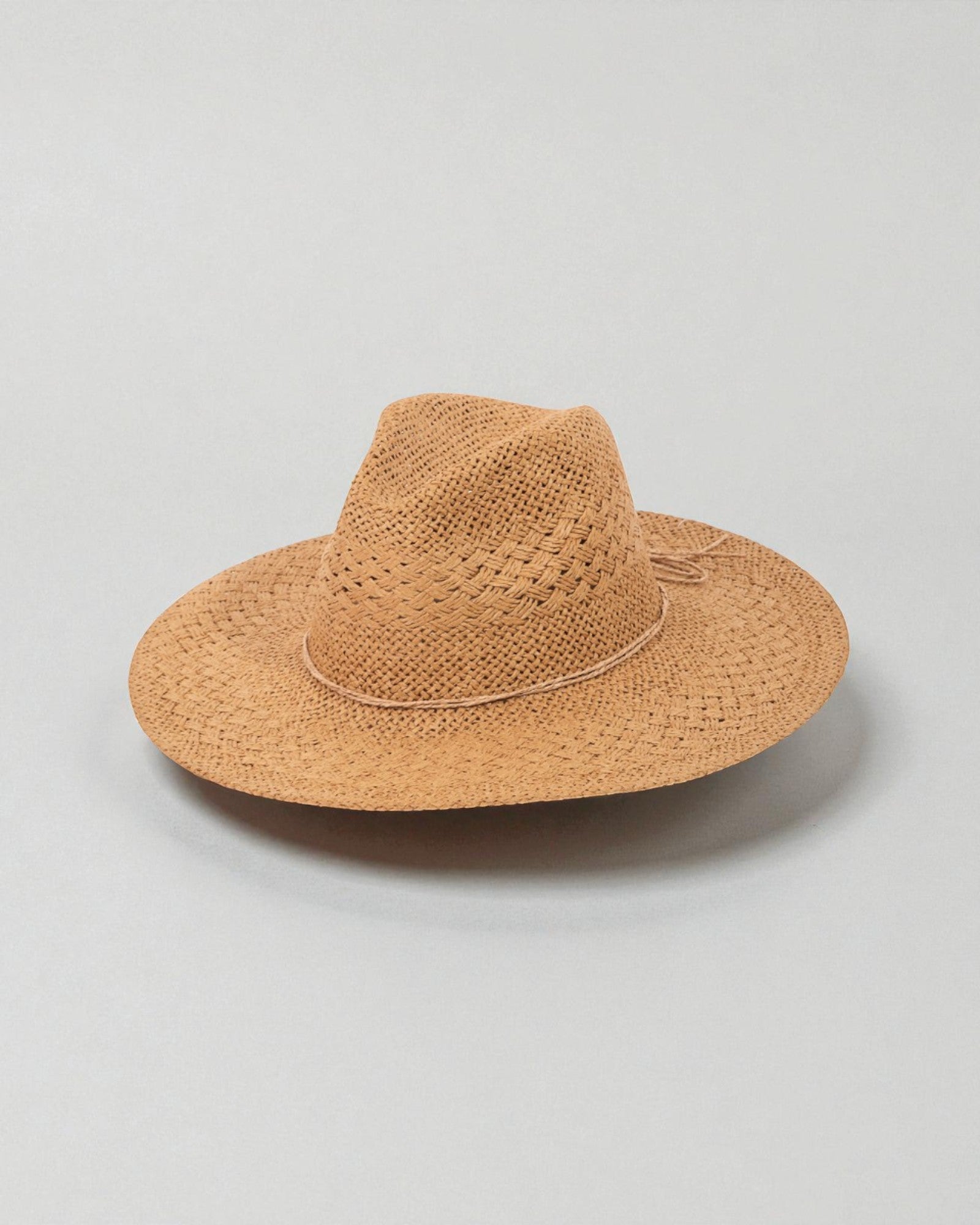 Brown straw hat on a light gray background