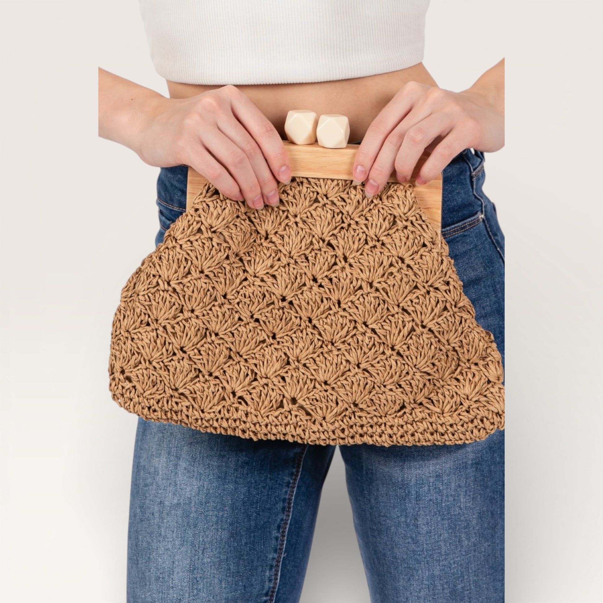 Person holding a woven bag with soap bars inside against a plain background