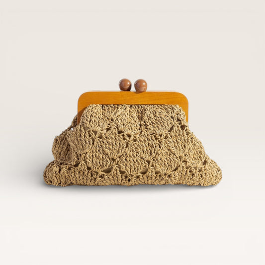 Crocheted clutch bag with wooden frame on a light background