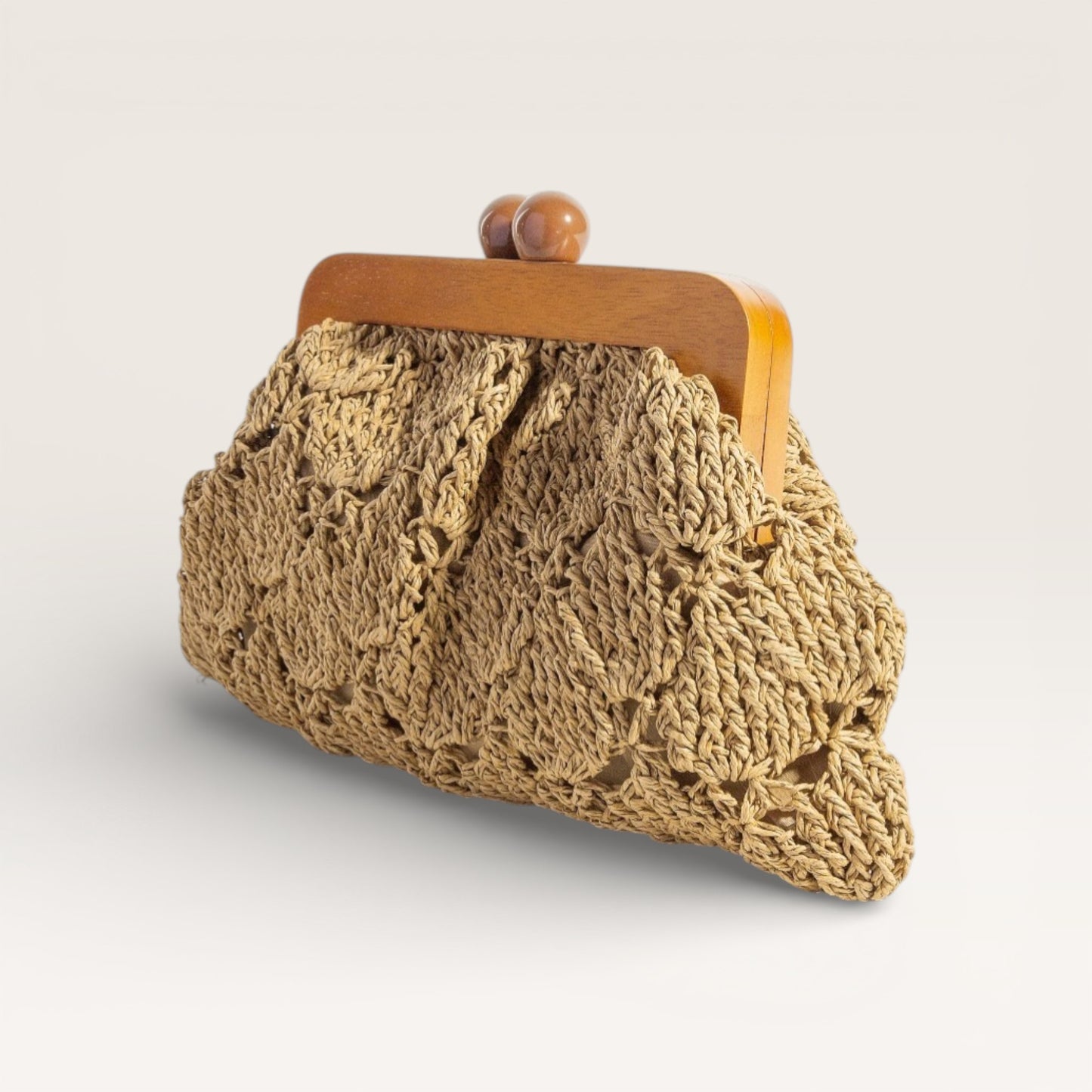 Knitted purse with wooden frame on a light background