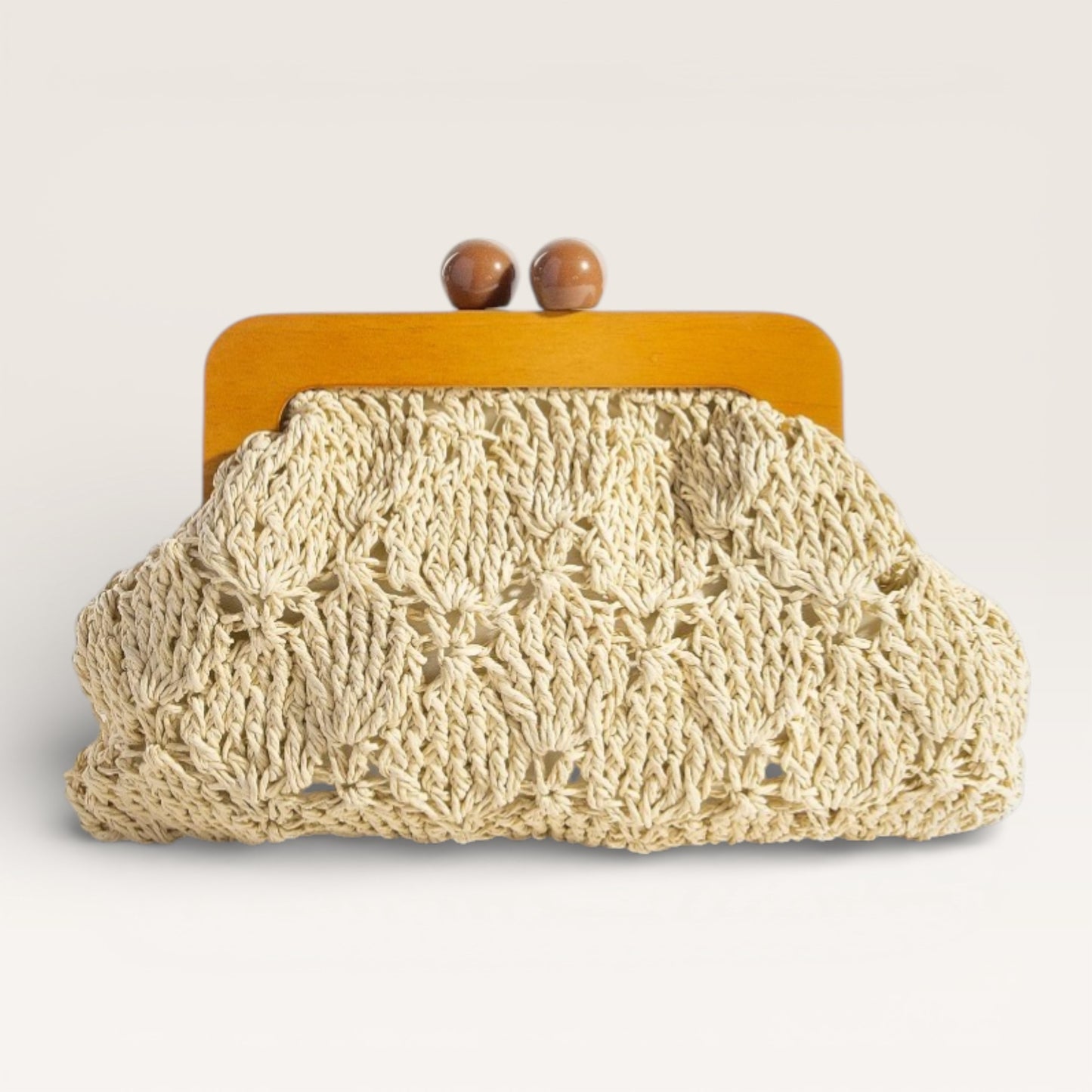 Crocheted clutch bag with wooden frame on a light background