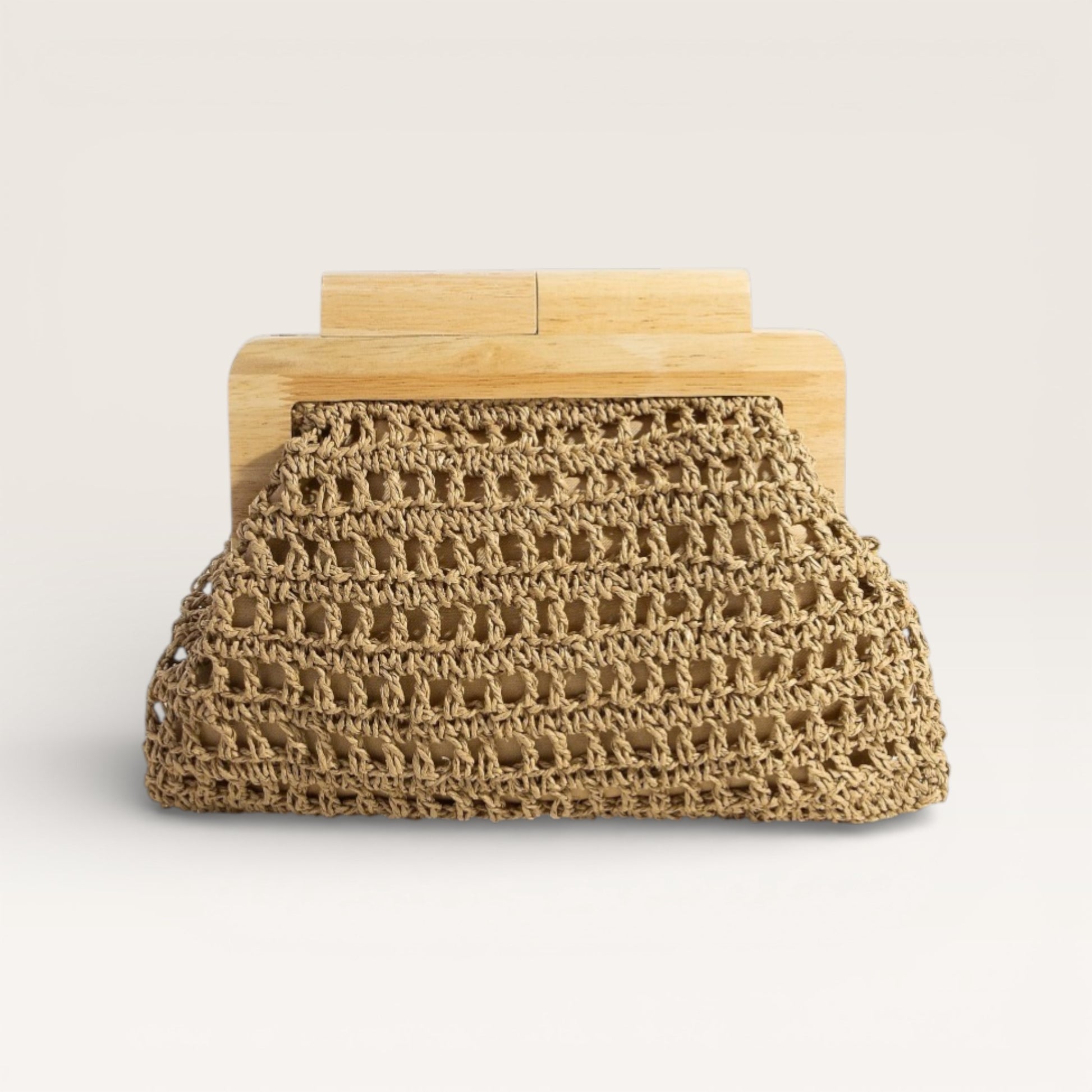 Clutch bag with woven design and wooden frame on a light background