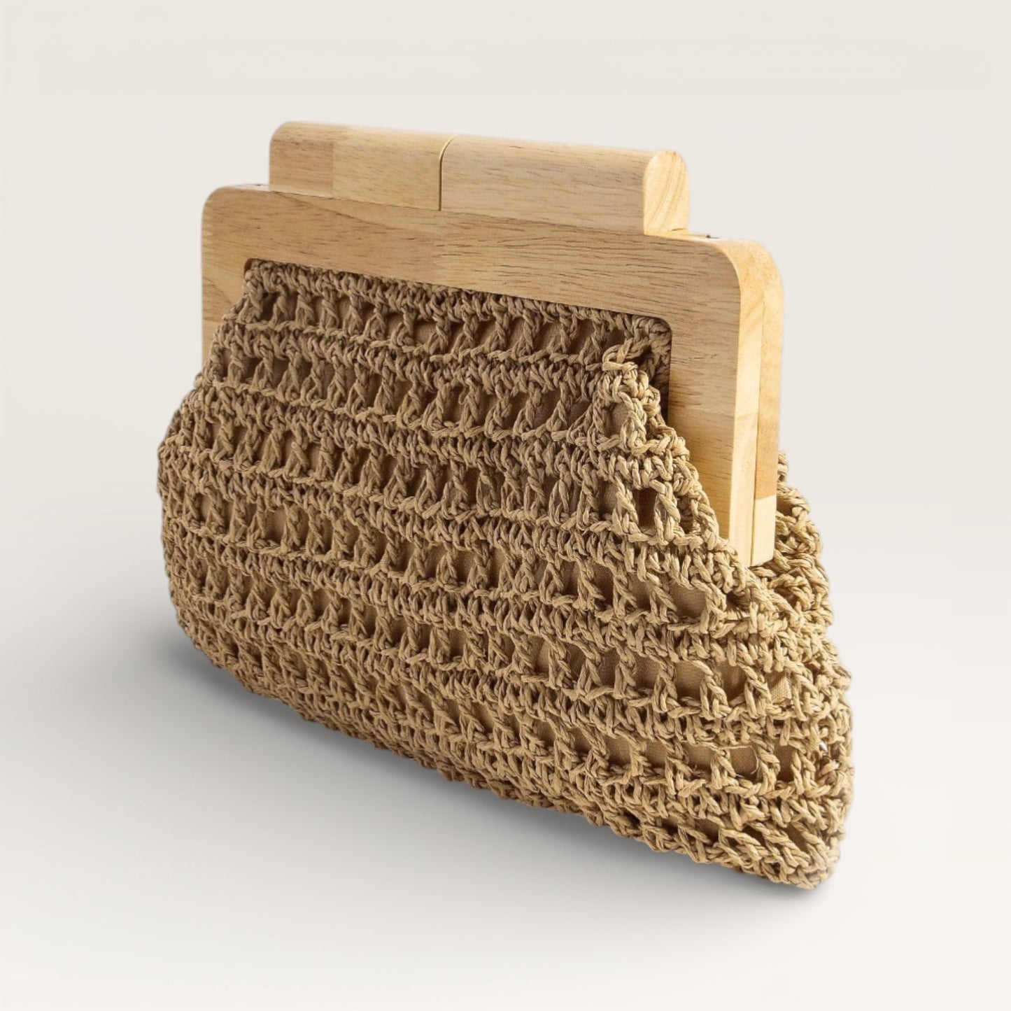 Brown woven clutch bag with wooden frame on a light gray background
